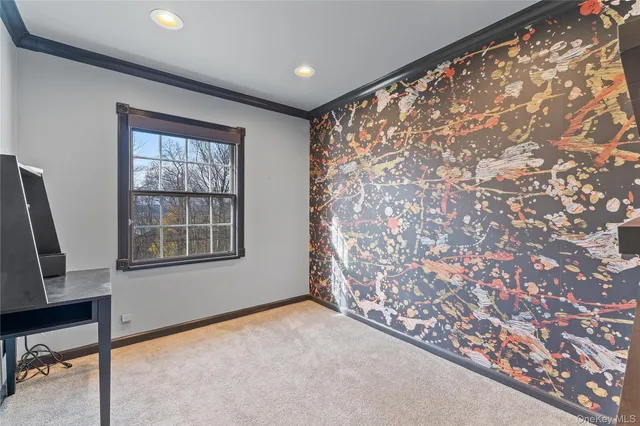 an empty room with a chandelier fan and windows