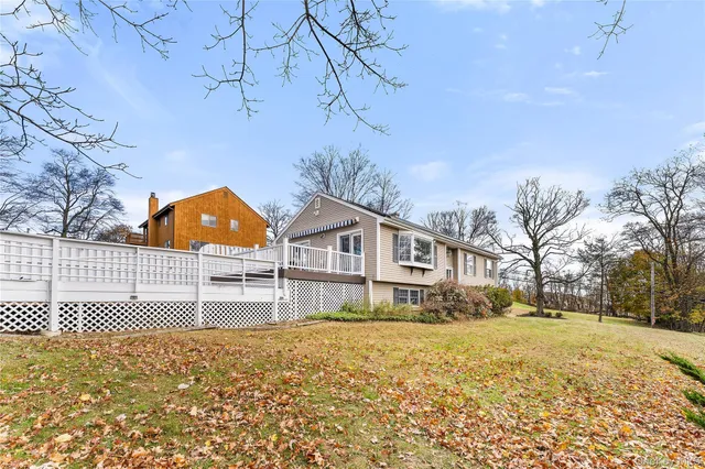 a view of house with a yard