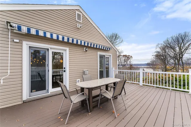 a view of a deck with furniture and wooden floor