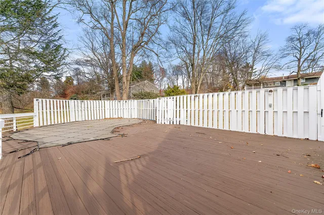 a view of a house with a deck and furniture