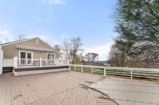 a view of backyard space with wooden fence