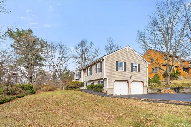 a view of a white house with a yard