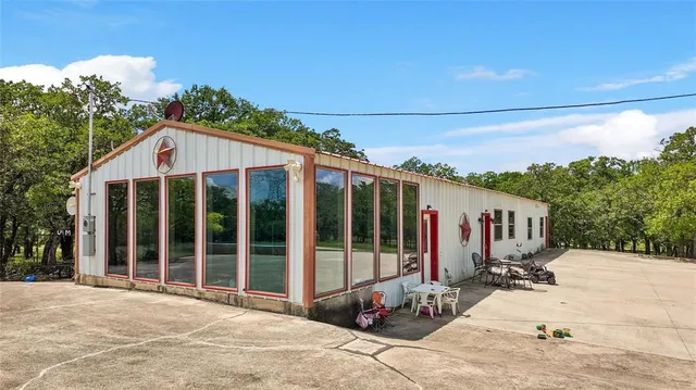 a living room with furniture and large windows