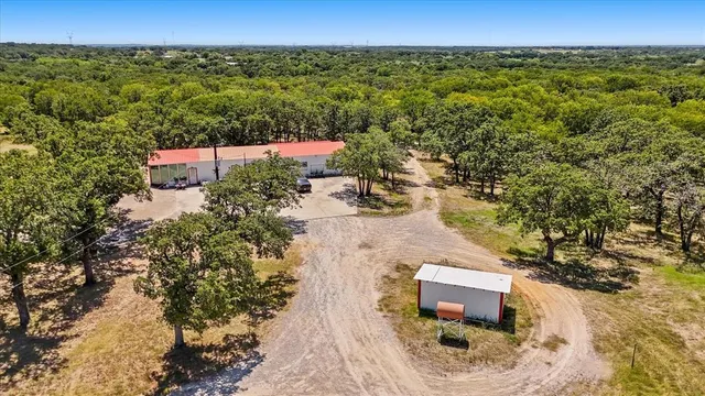 an aerial view of a house with a yard