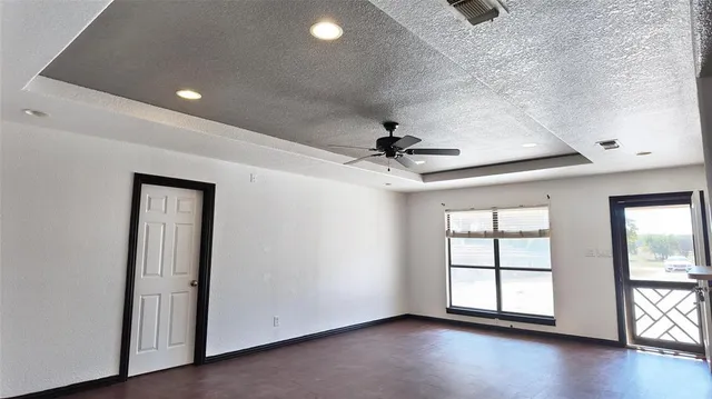 a view of a chandelier in big room and chandelier fan