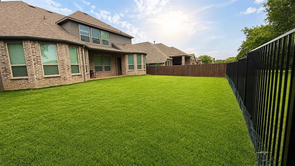 912 Fallbrook Avenue Denton, TX 76210 - Photo 25 of 26 a view of a house with backyard and garden