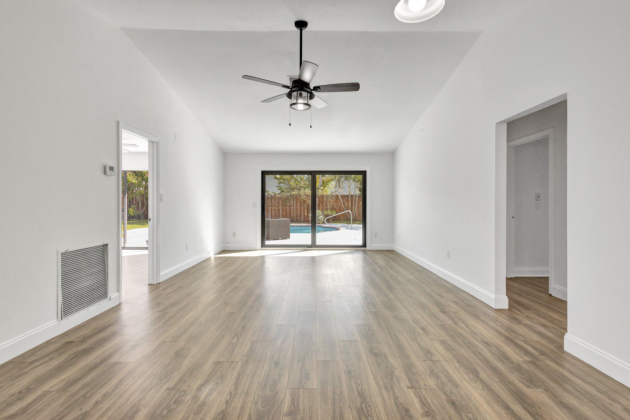 9404 Longmeadow Circle Boynton Beach, FL 33436 - Photo 13 of 28 a view of an empty room with wooden floor and a window