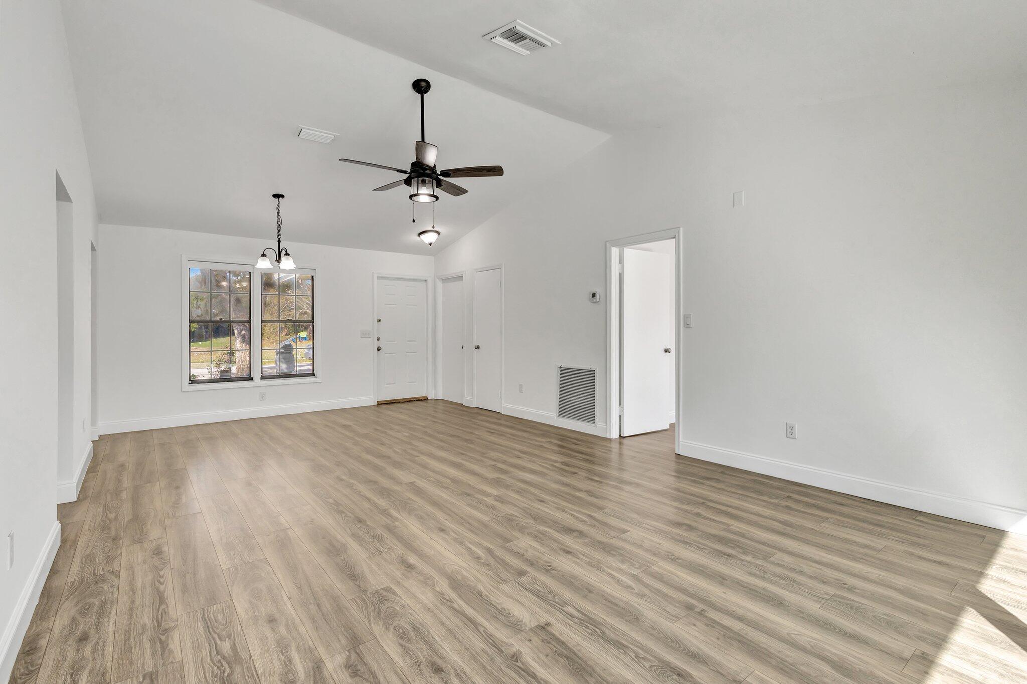 9404 Longmeadow Circle Boynton Beach, FL 33436 - Photo 16 of 28 an empty room with wooden floor ceiling fan and window