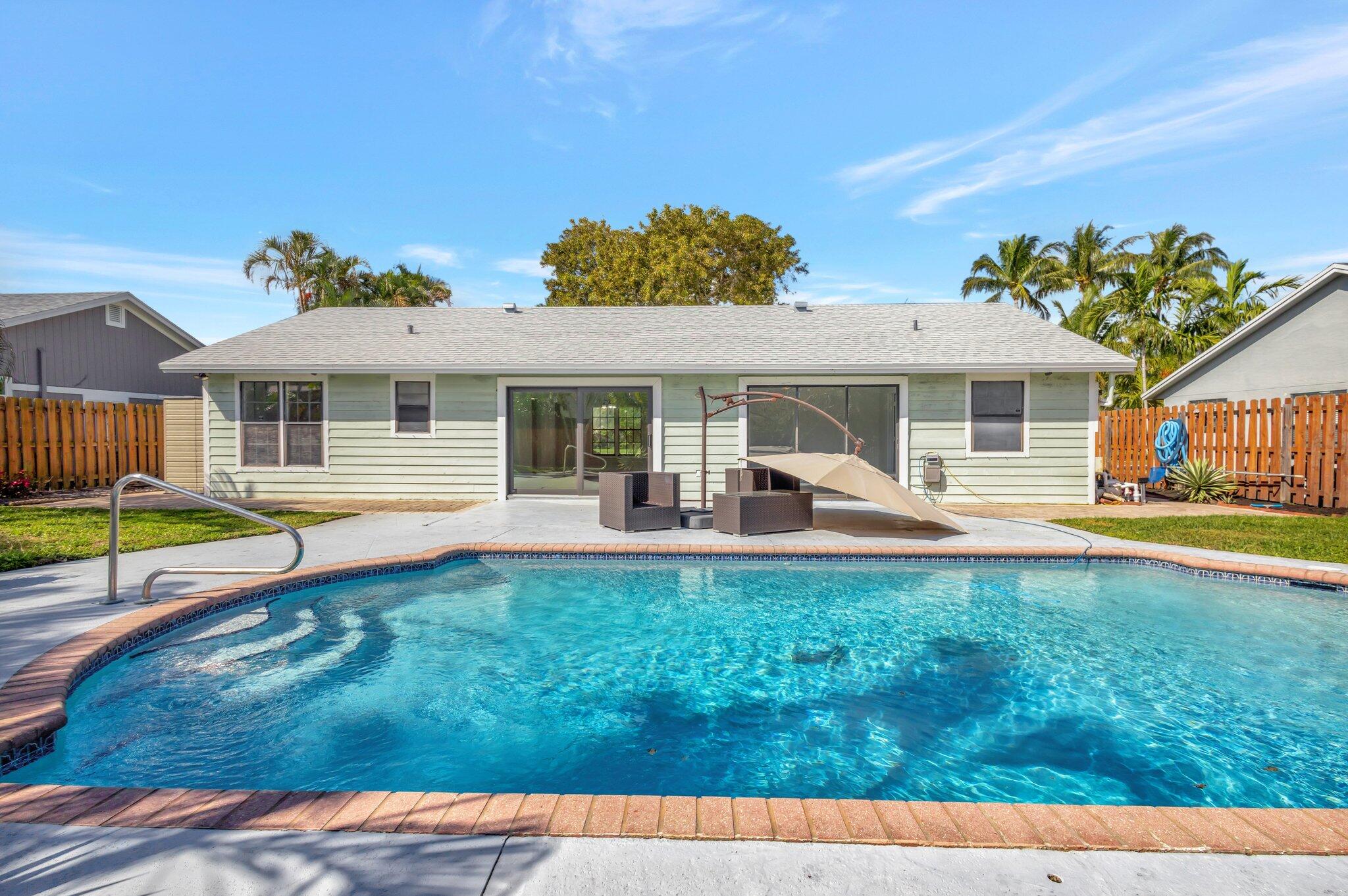 9404 Longmeadow Circle Boynton Beach, FL 33436 - Photo 8 of 28 a view of a house with a backyard and a small pool