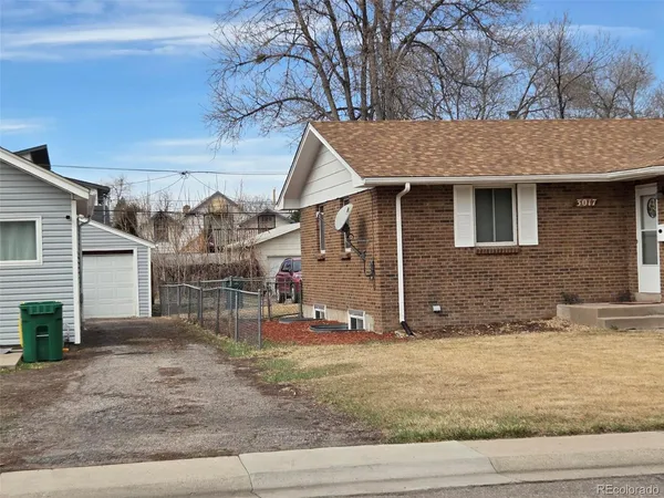 a view of a house with a wooden fence