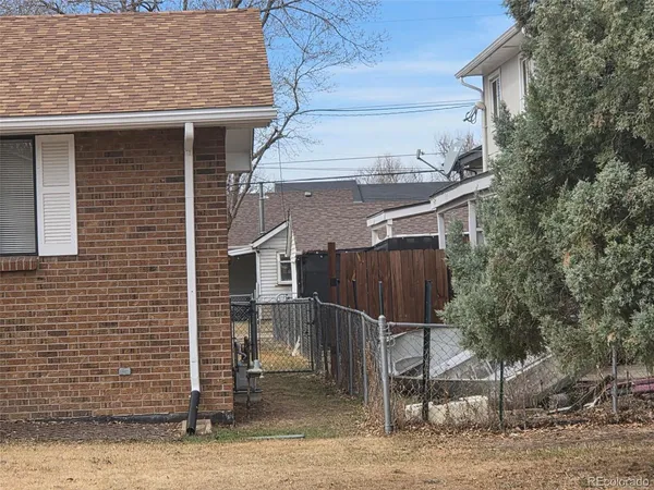 a front view of a house with cars parked