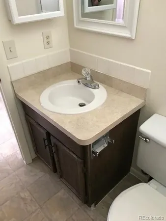 an empty room with a fireplace and windows