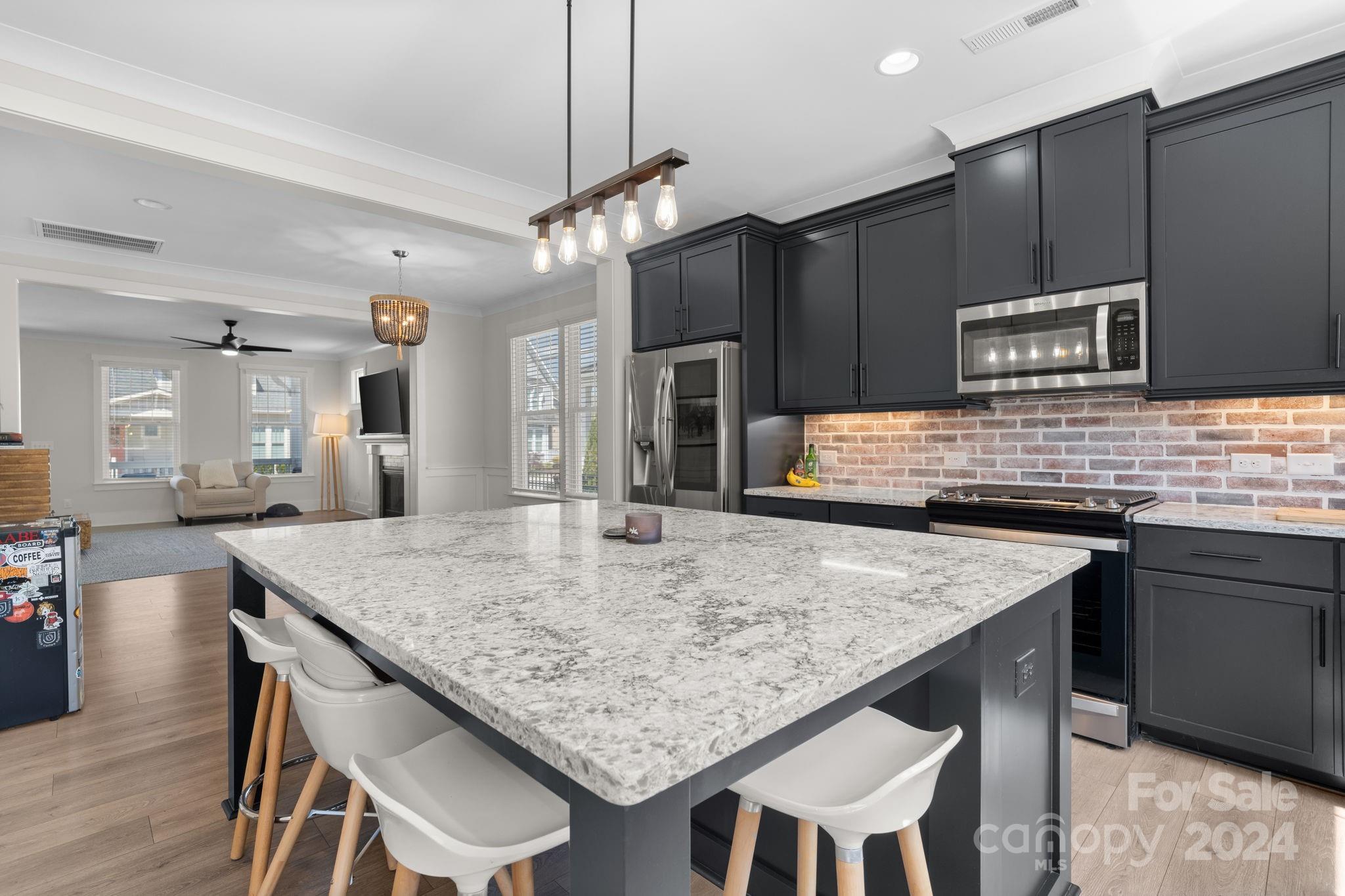 815 Bluff Loop Road Rock Hill, SC 29730 - Photo 12 of 35 a kitchen with center island and stainless steel appliances