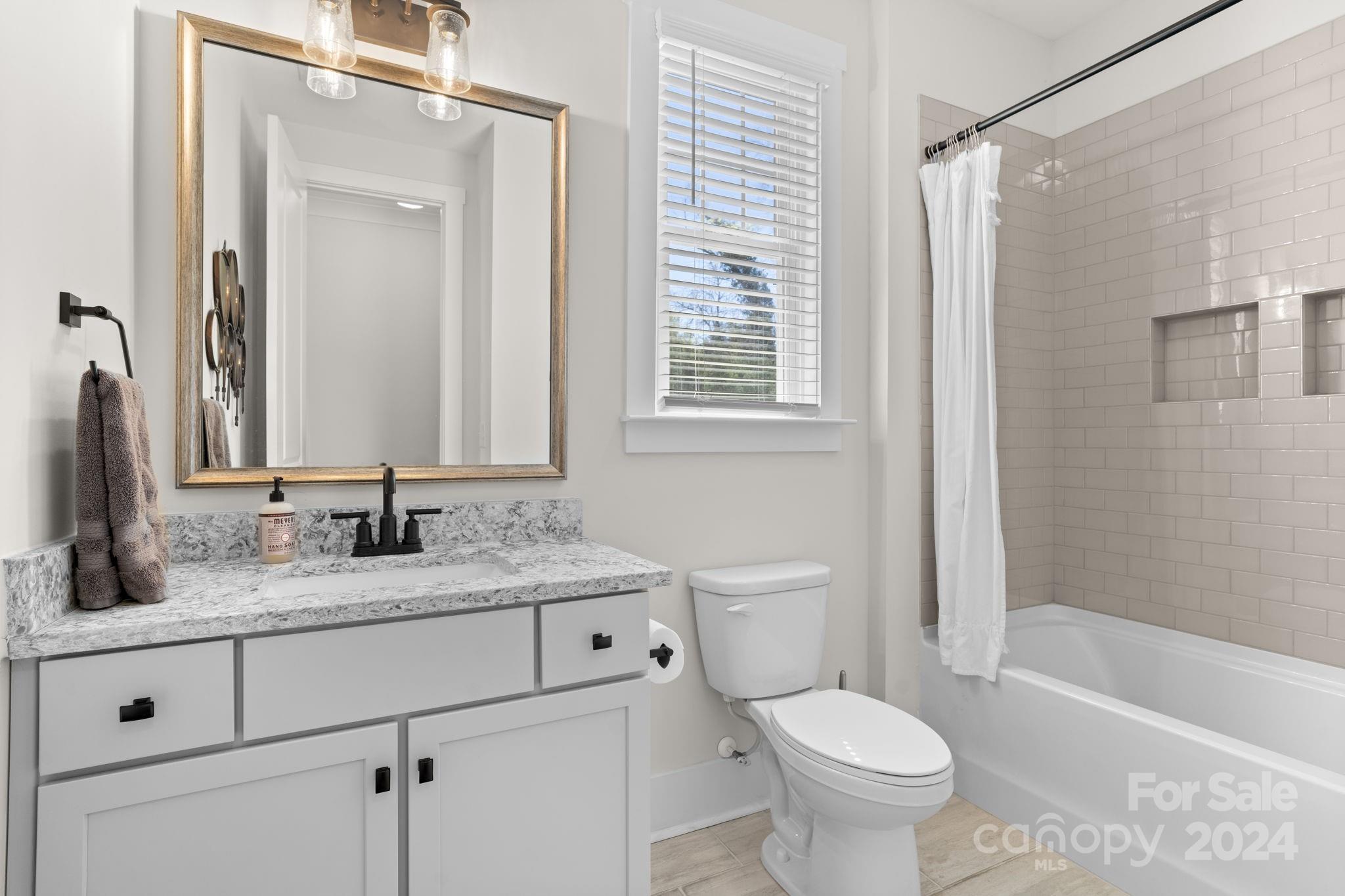 815 Bluff Loop Road Rock Hill, SC 29730 - Photo 16 of 35 a bathroom with a granite countertop toilet sink and mirror