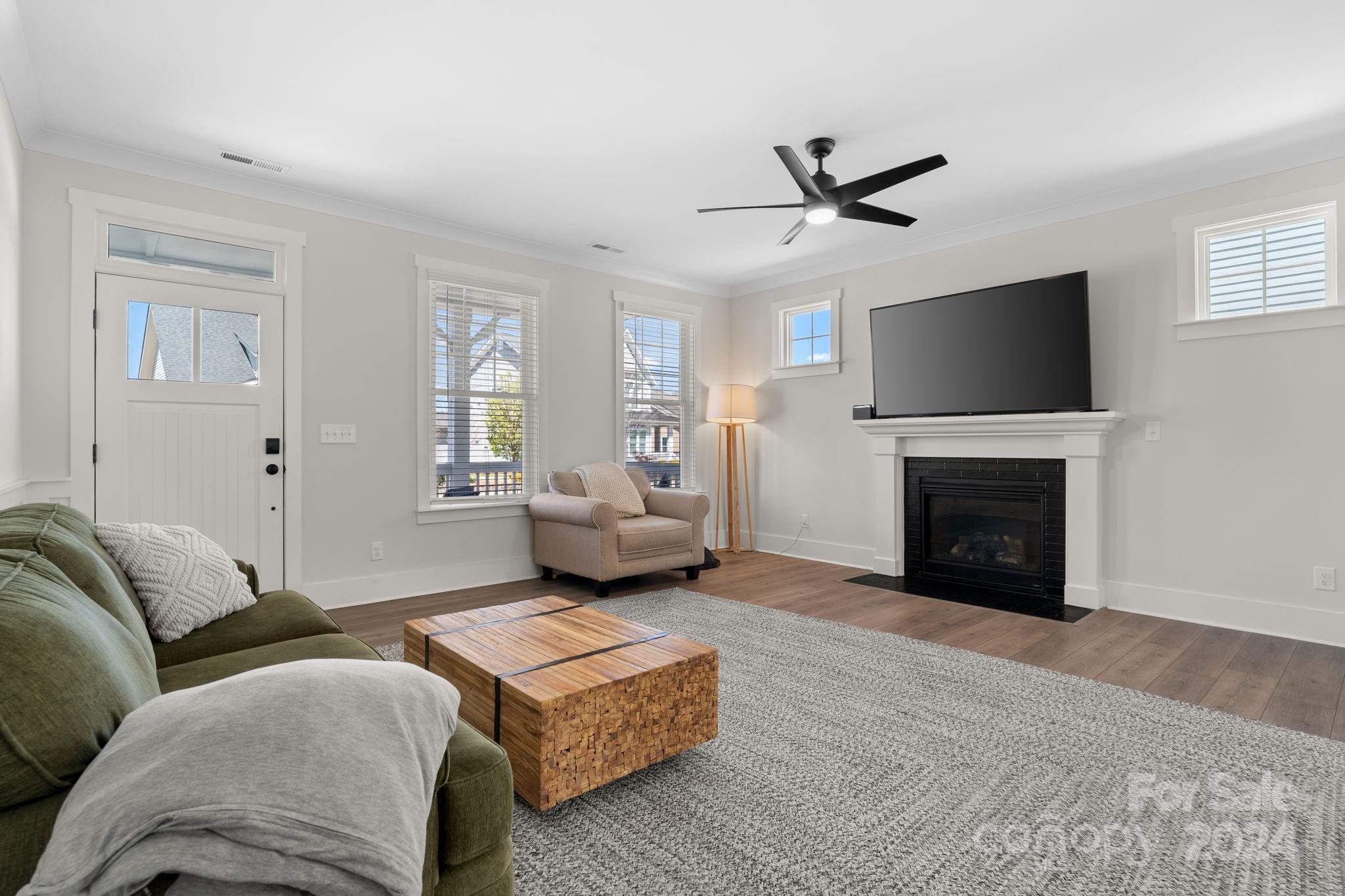 815 Bluff Loop Road Rock Hill, SC 29730 - Photo 6 of 35 a living room with furniture a fireplace and a flat screen tv