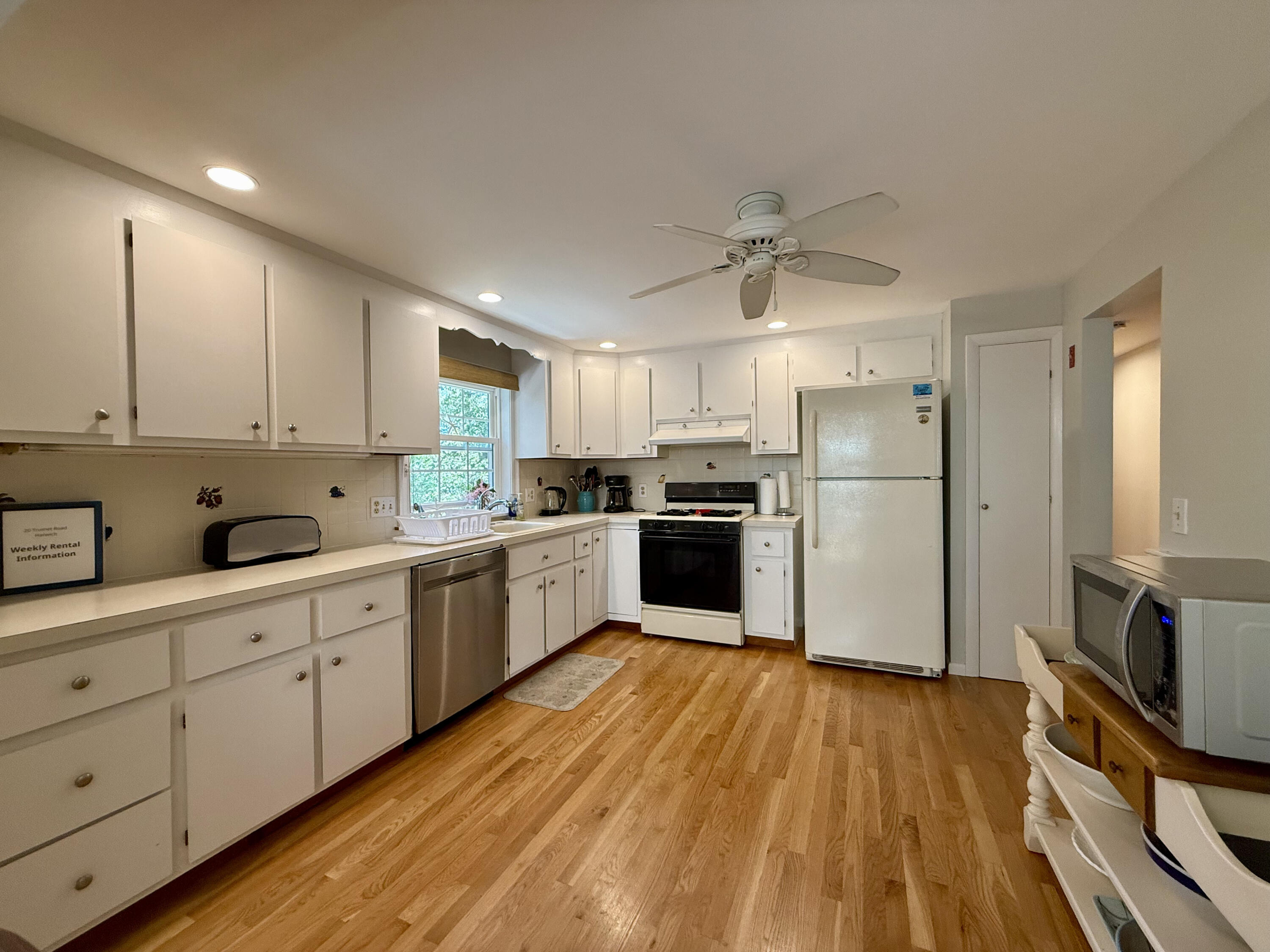 20 Trumet Road West Harwich, MA 02671 - Photo 12 of 21 a kitchen with white cabinets and stainless steel appliances