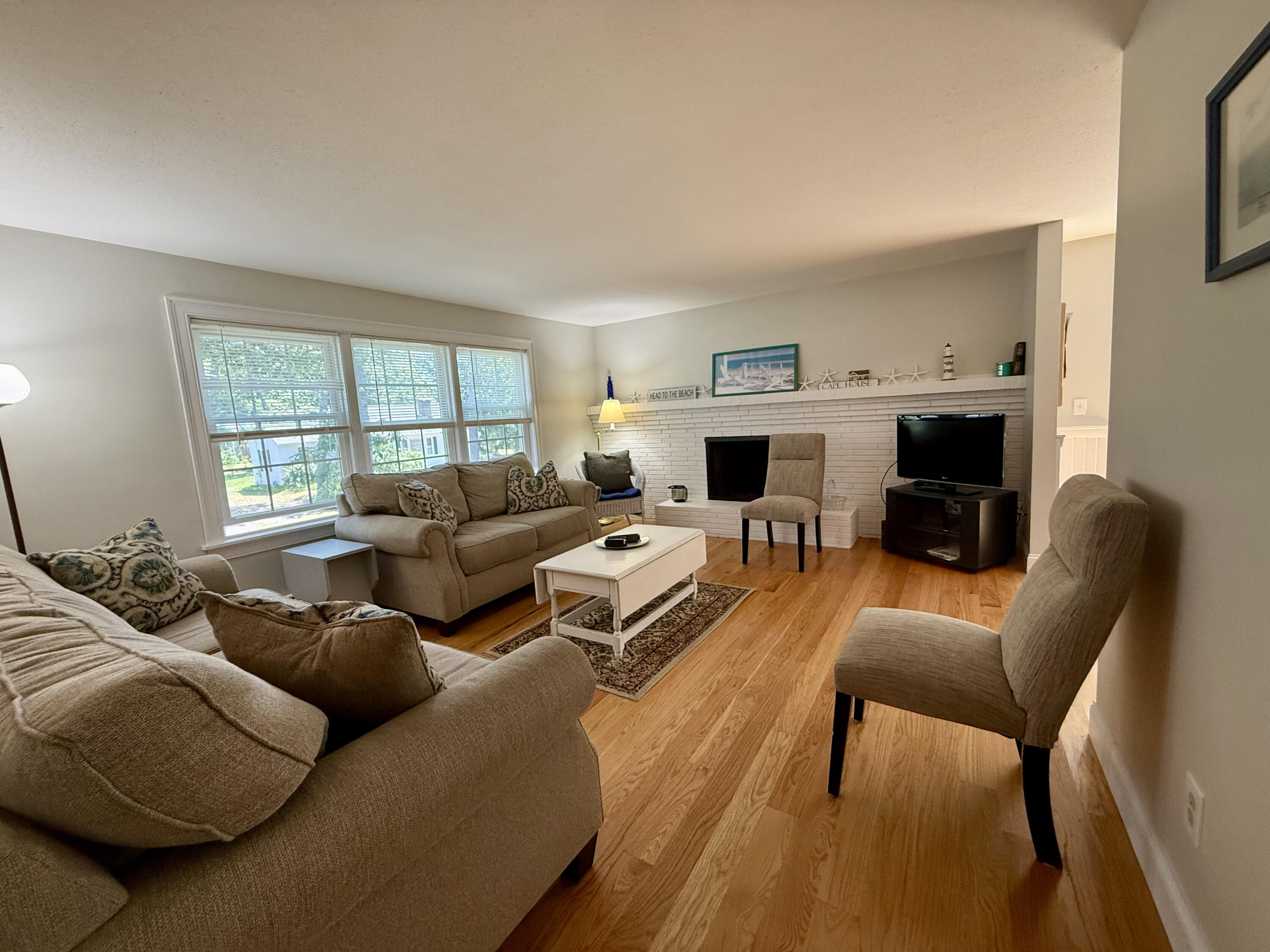 20 Trumet Road West Harwich, MA 02671 - Photo 6 of 21 a living room with furniture large window and a fireplace