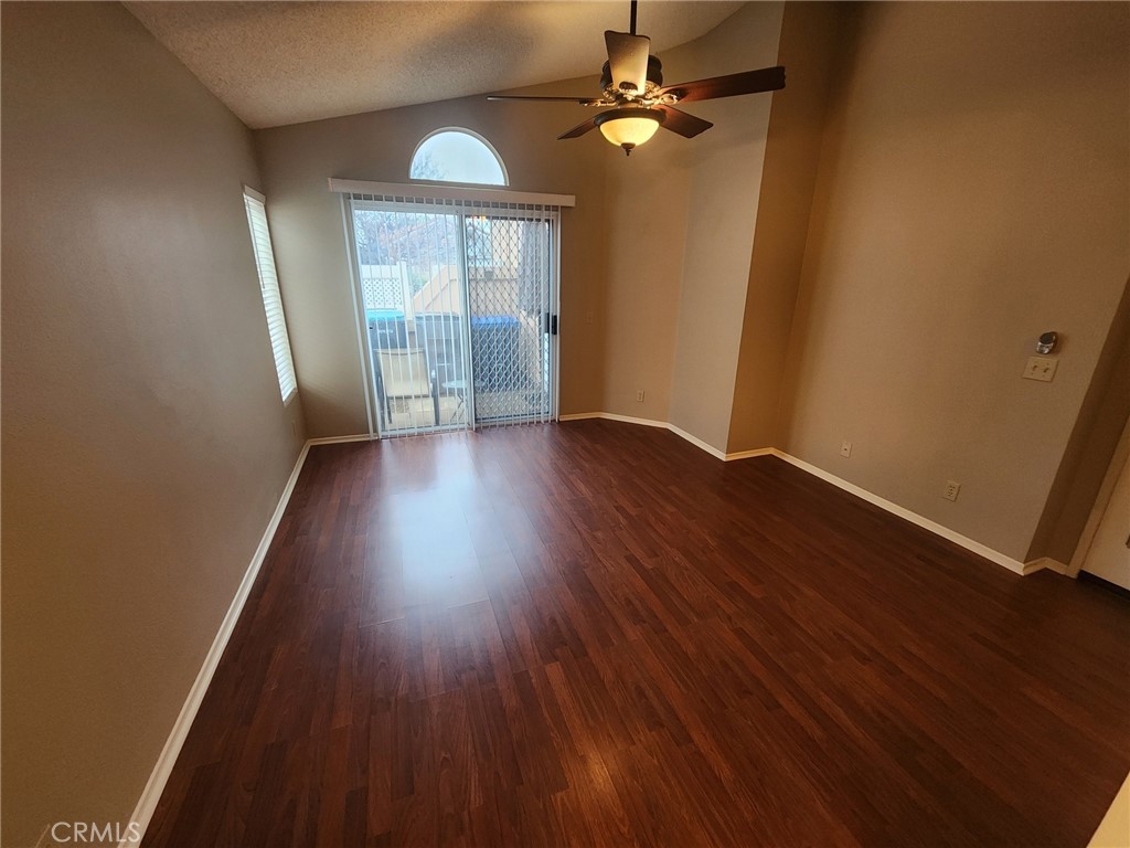 29806 Coral Tree Court Menifee, CA 92584 - Photo 11 of 29 an empty room with wooden floor fan and windows