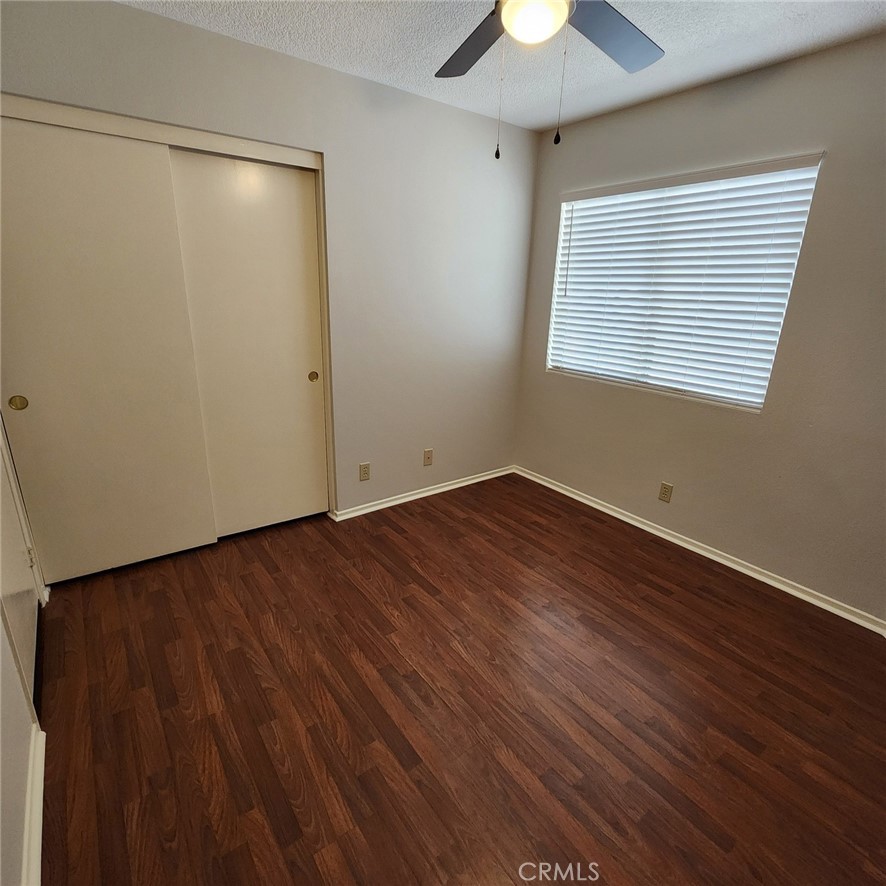 29806 Coral Tree Court Menifee, CA 92584 - Photo 24 of 29 wooden floor in an empty room with a window