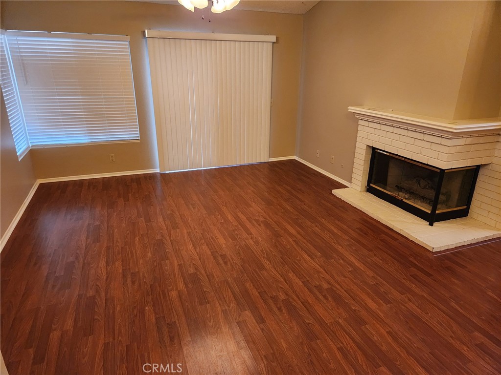 29806 Coral Tree Court Menifee, CA 92584 - Photo 4 of 29 a view of an empty room with wooden floor and a window