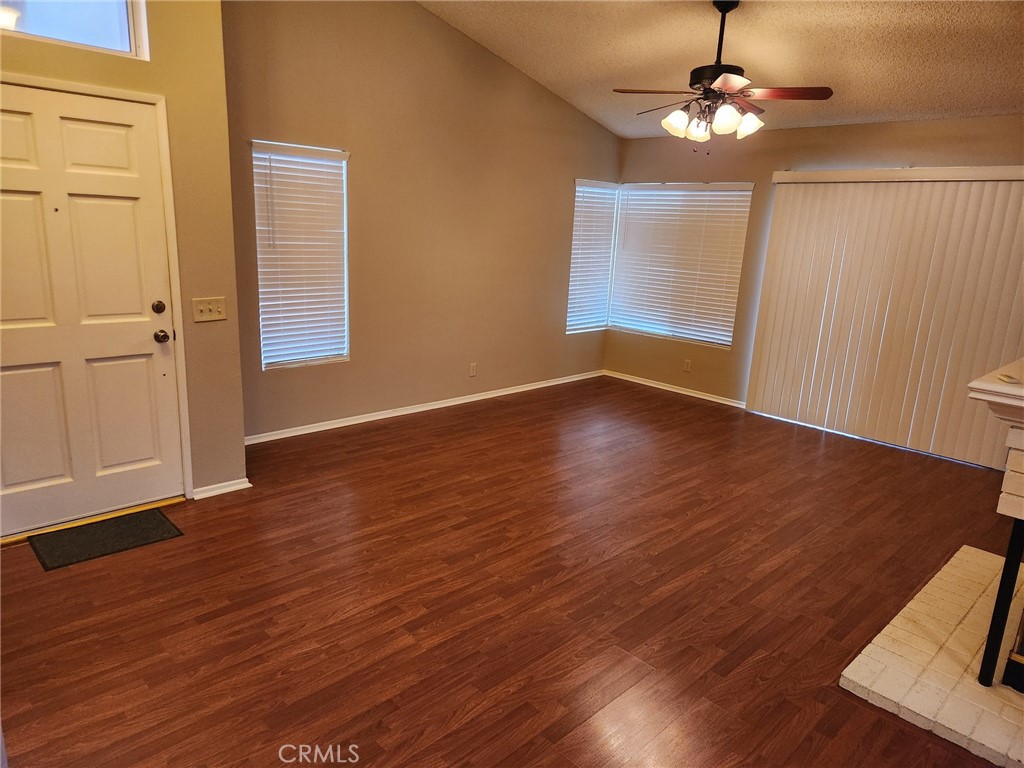 29806 Coral Tree Court Menifee, CA 92584 - Photo 5 of 29 a view of empty room with wooden floor and fan