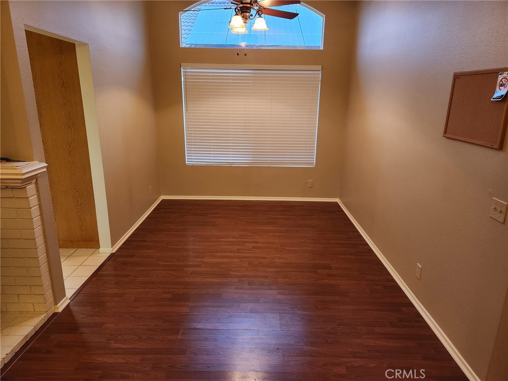 29806 Coral Tree Court Menifee, CA 92584 - Photo 7 of 29 a view of an empty room with wooden floor and a window