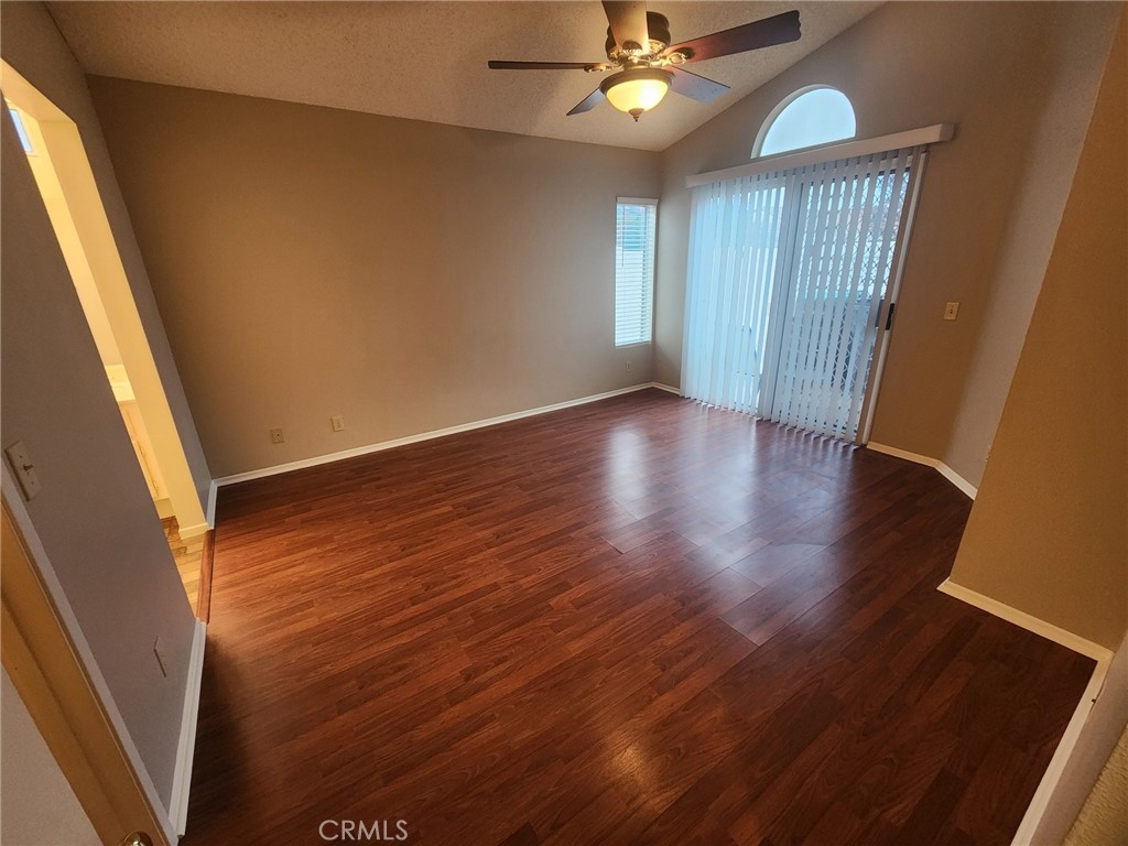 29806 Coral Tree Court Menifee, CA 92584 - Photo 10 of 29 an empty room with wooden floor fan and windows