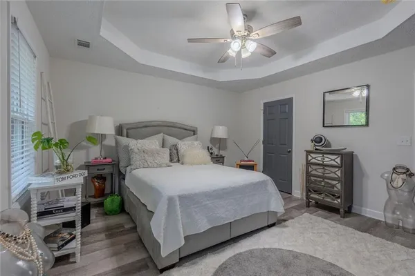 a bedroom with a bed and a chandelier