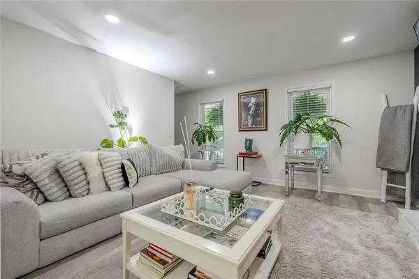 a living room with furniture and wooden floor