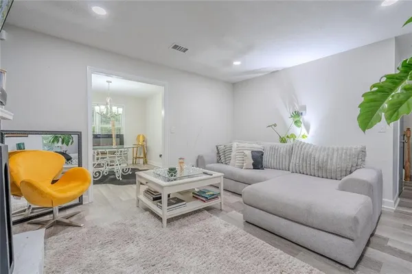 a living room with furniture and a lamp