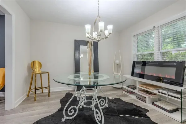 a living room with furniture a flat screen tv and a large window