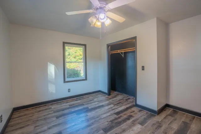 a living room with a baby crib furniture and a window