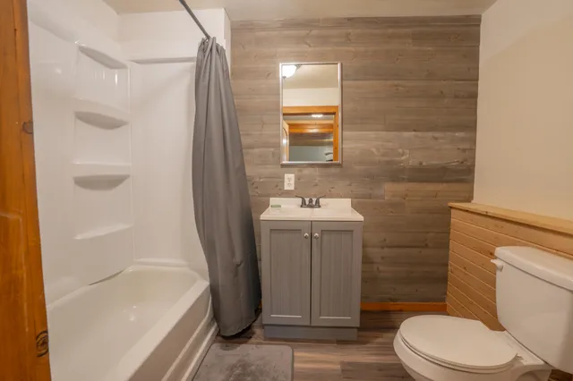 a kitchen with stainless steel appliances granite countertop a sink cabinets and wooden floor