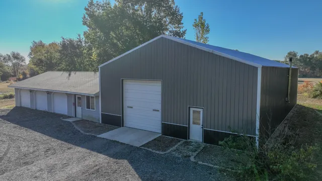 a front view of house with yard and trees around
