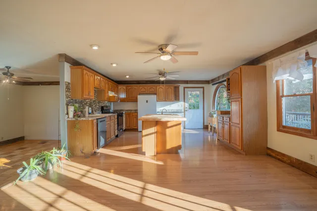 a view of kitchen with furniture and wooden floor