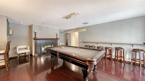 a living room with furniture a table and wooden floor