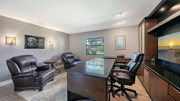 a living room with furniture a flat screen tv and a window