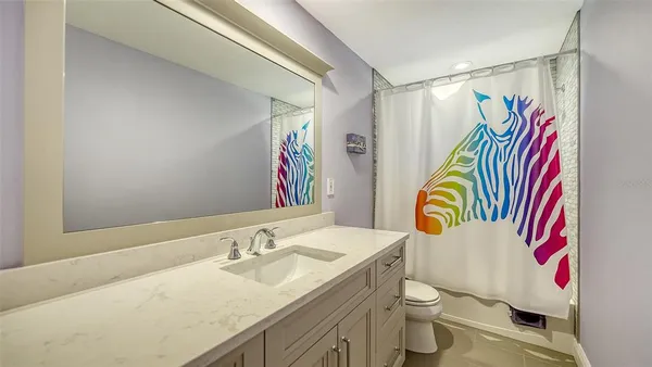 a bathroom with a sink vanity mirror and toilet