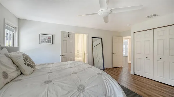 a spacious bedroom with a bed and a window