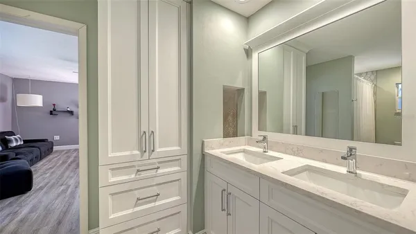 a bathroom with a double vanity sink and a mirror