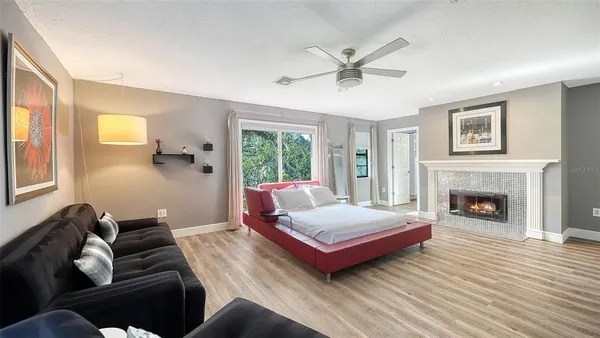 a living room with a bed furniture and a fireplace