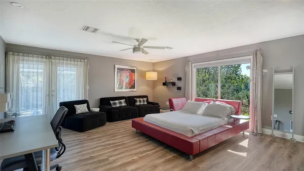 a living room with furniture rug and wooden floor