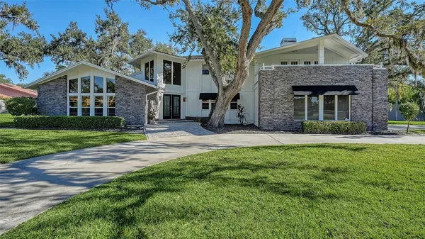 a front view of a house with yard and green space