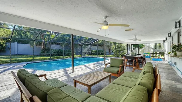 a view of a dining room with furniture wooden floor and garden view