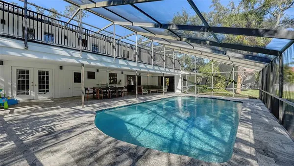 a view of a swimming pool with outdoor seating