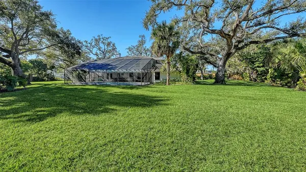 a backyard of a house with table and chairs