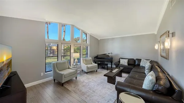 a living room with furniture and a floor to ceiling window