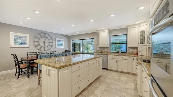 a kitchen with granite countertop cabinets a sink and appliances