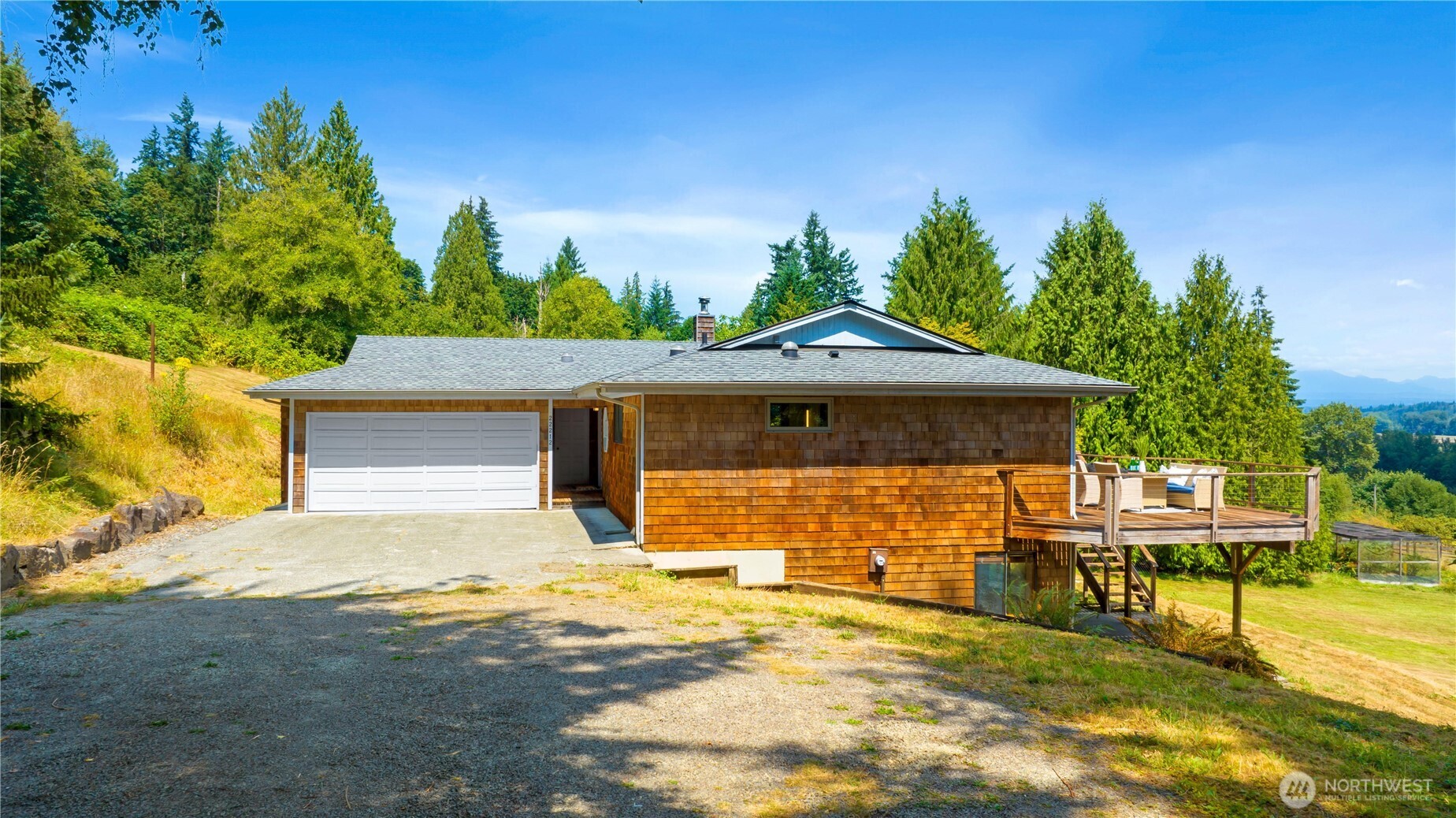 22212 High Bridge Road Monroe, WA 98272 - Photo 3 of 34 a front view of a house with a yard and garage