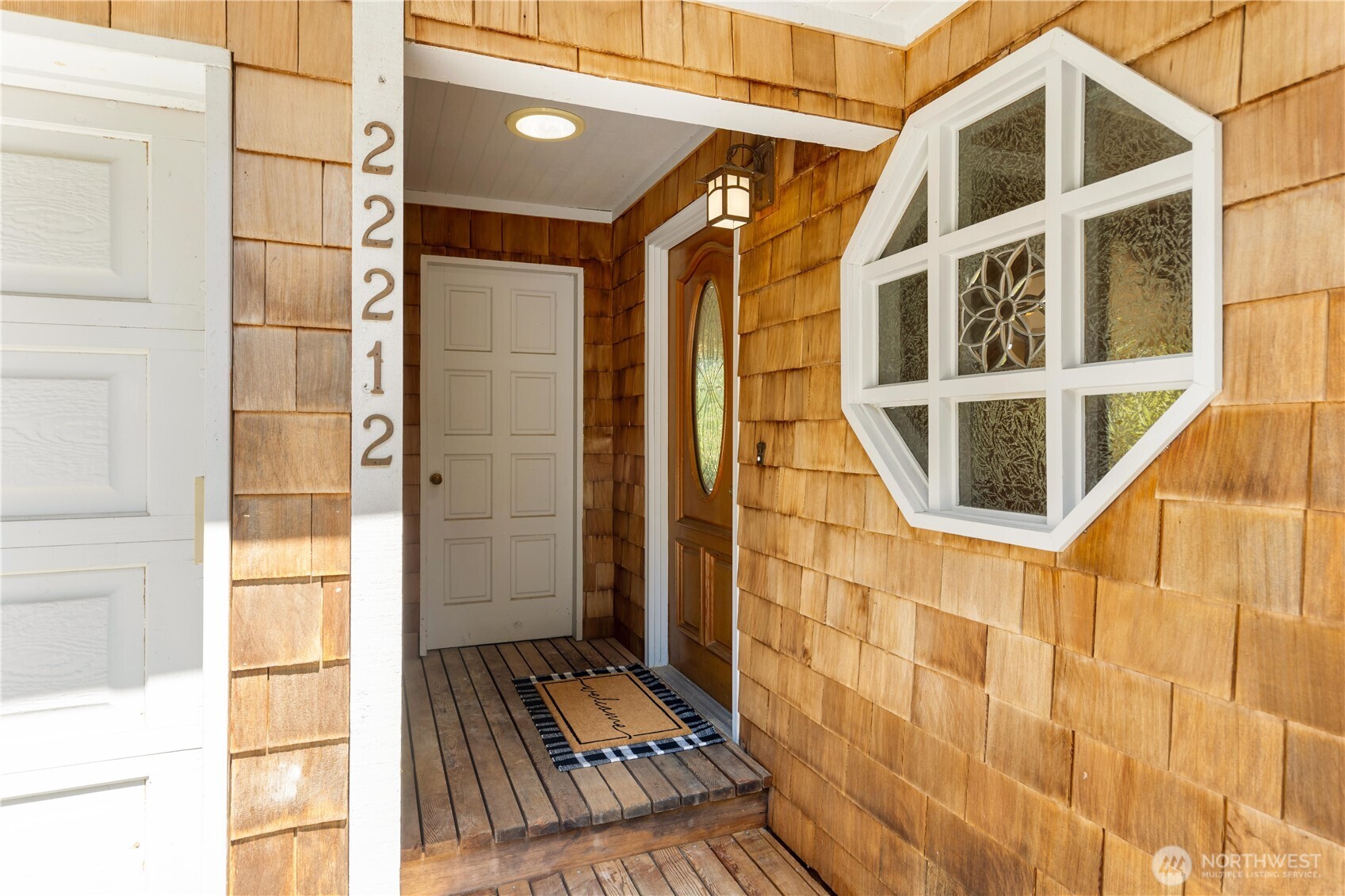 22212 High Bridge Road Monroe, WA 98272 - Photo 4 of 34 a view of a balcony with wooden floor and a potted plant